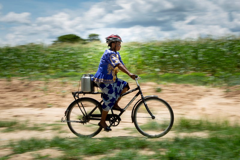 A dairy farmer riding a pay-as-you-go bike